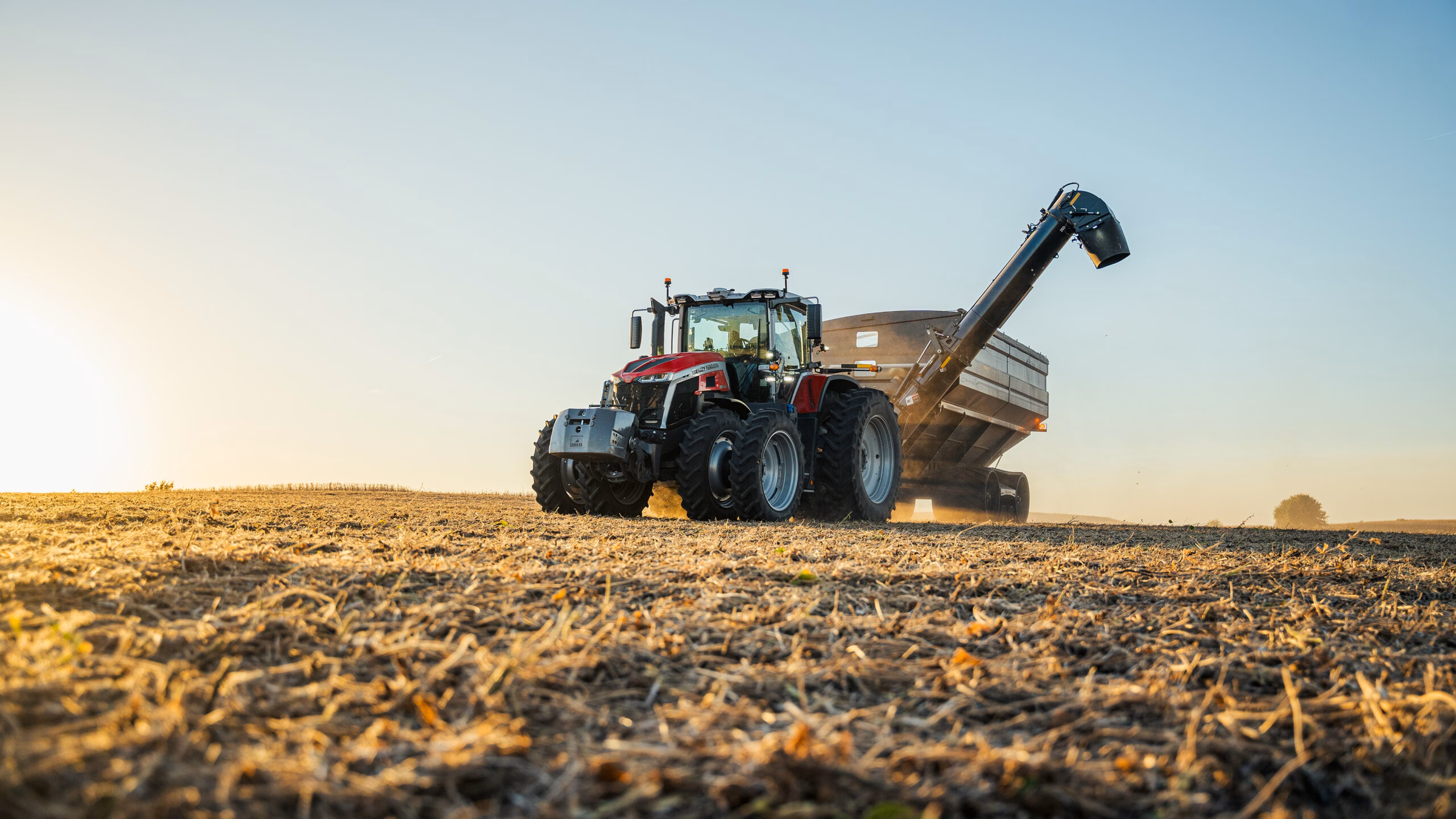 Massey Ferguson 9S pulling a Grain Cart.
